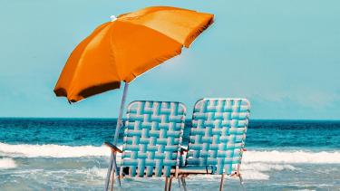 Two Beach chairs on the Beach under an umbrella