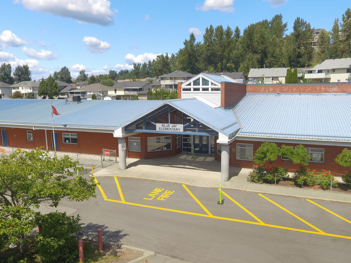 Exterior image of elementary school with blue sky in the background, entrance to the building.