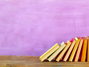 Stacked books with purple background