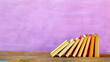 Stacked books with purple background