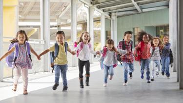 Elementary kids run holding hands
