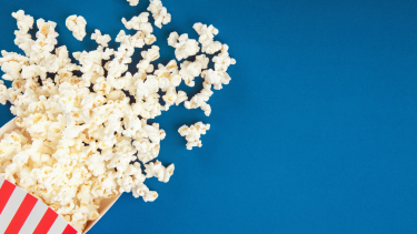 Popcorn - Blue Background Bag of popcorn on a blue background